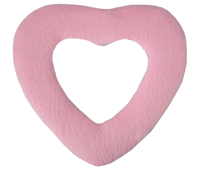 a pink heart shaped pillow on a white background