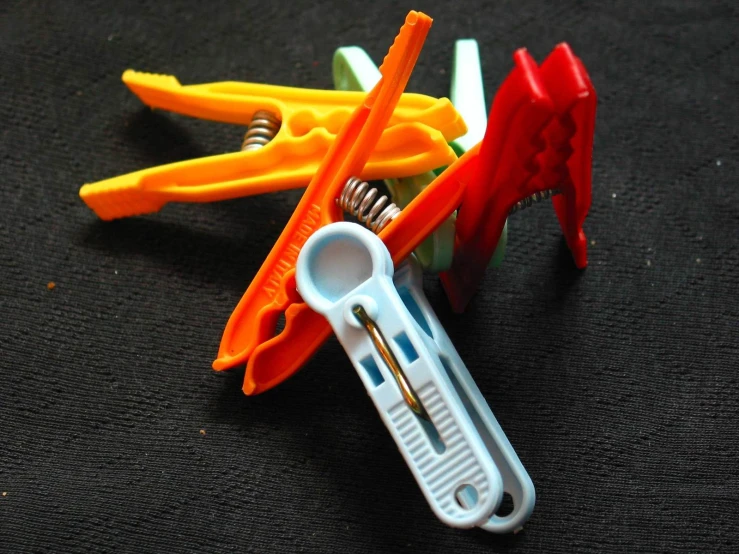 orange toothbrushes are stuck in the holder with glue