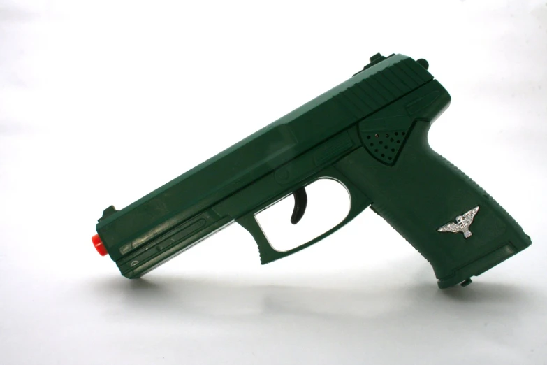 a toy gun on display against a white background