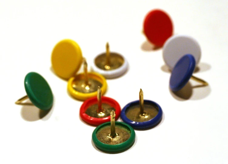 seven different colored wood ons with a screw