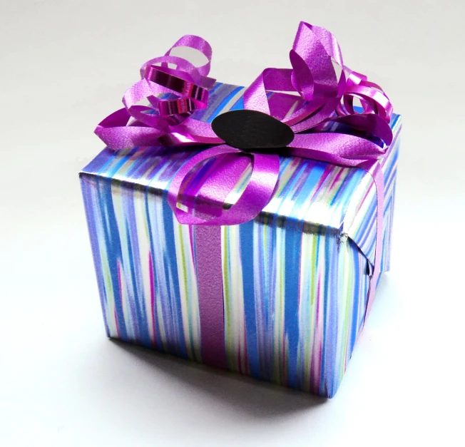 a striped wrapping box with a bow on top