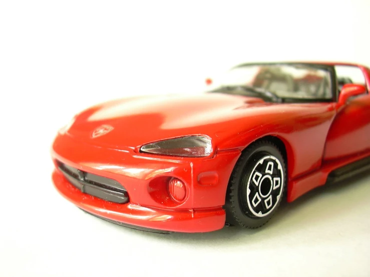 a red toy car on white background