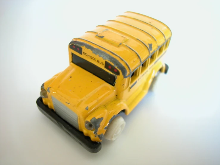 the front of a toy school bus on a white surface