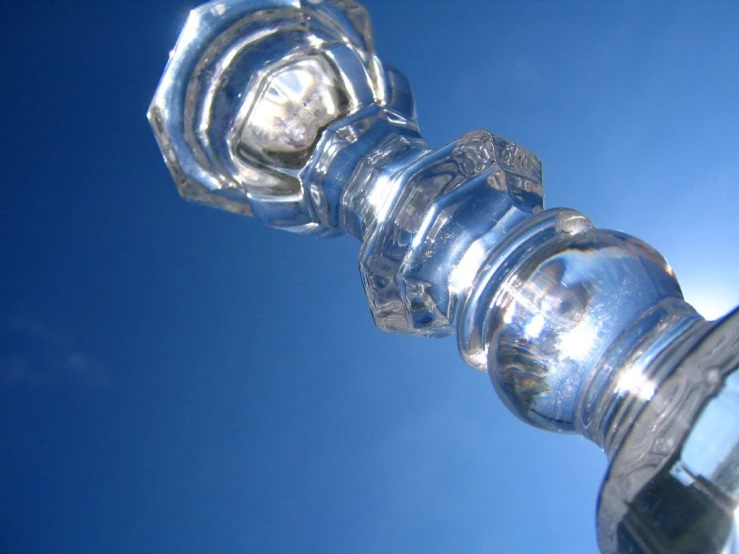 a close up of a small glass object in the sky
