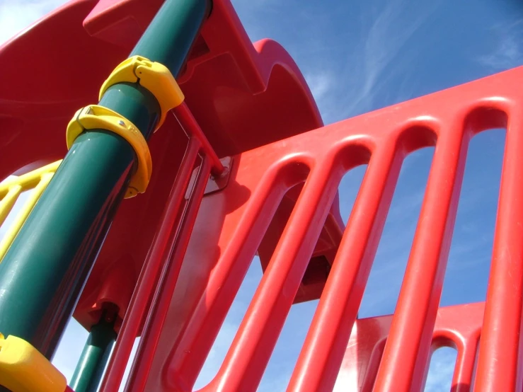 colorful children's playground equipment with blue sky in background