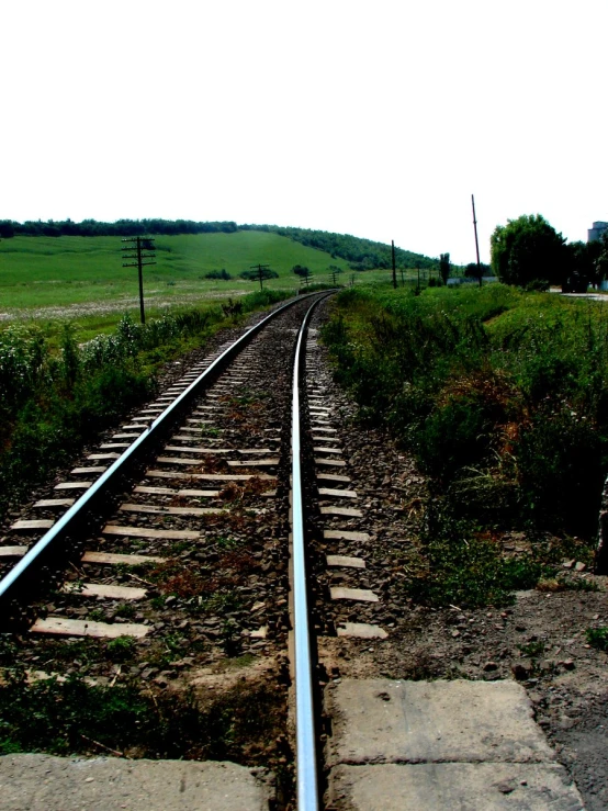 an empty track is next to a grassy area