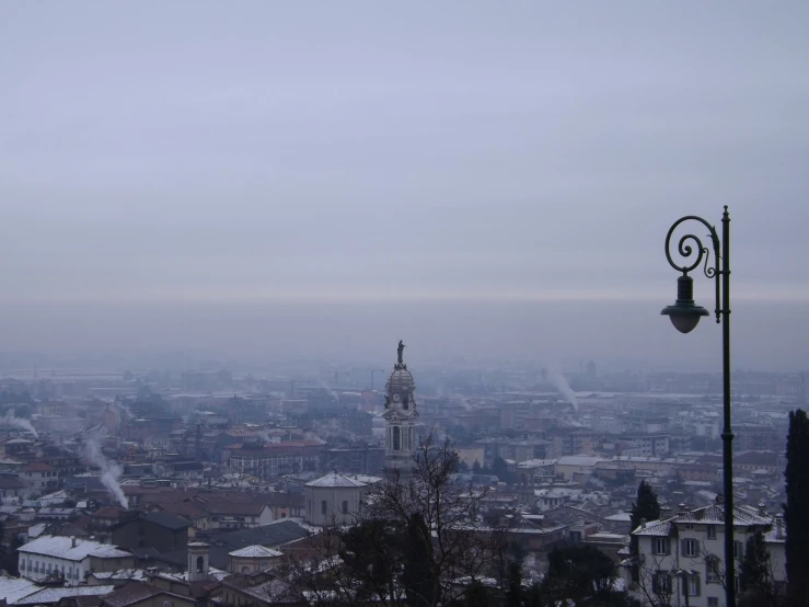 a lamp post and tower above a city