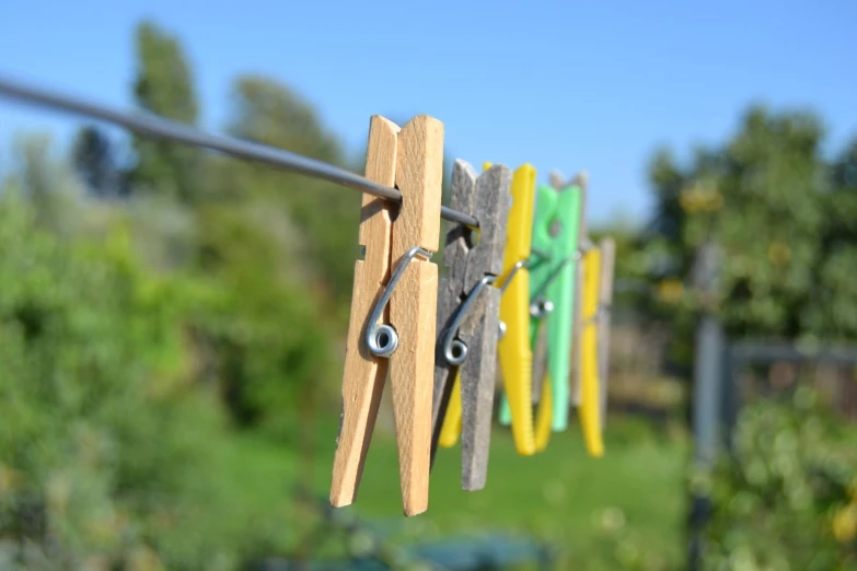 clothes pins and eyeglasses hang on a clothes line