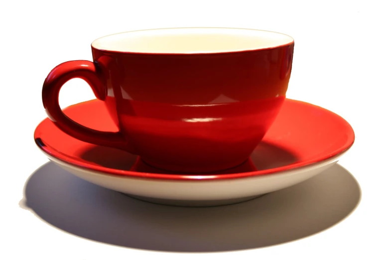 red and white cups and saucers sitting next to each other