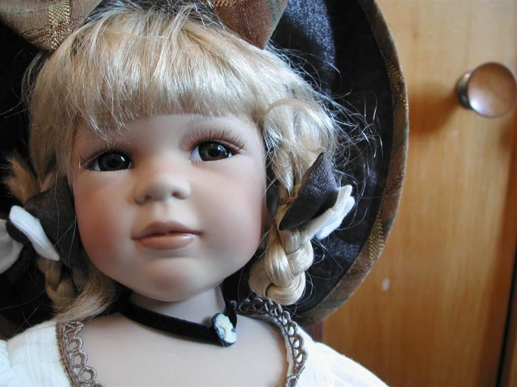 an old fashioned doll is wearing a hat
