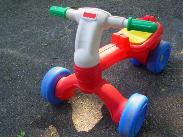 an odd shape plastic toy car laying on the ground