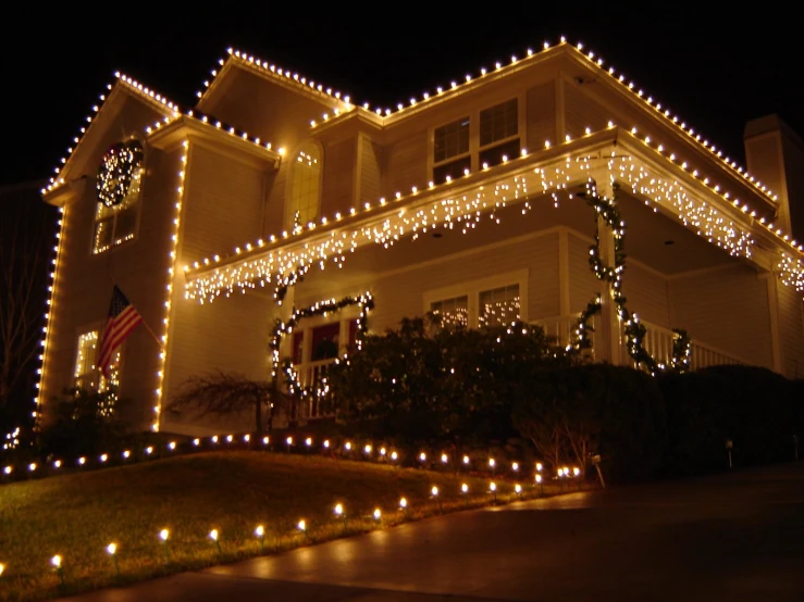 a house covered in christmas lights and garlands