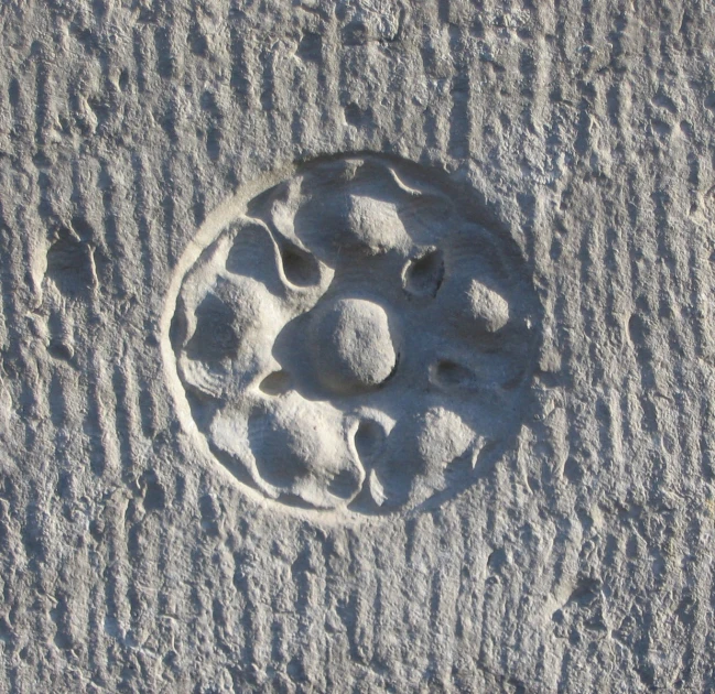 two little rocks and a carved circle in the sand