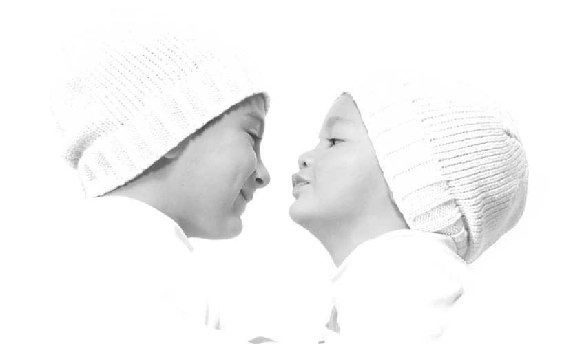 two young children face to face, in black and white