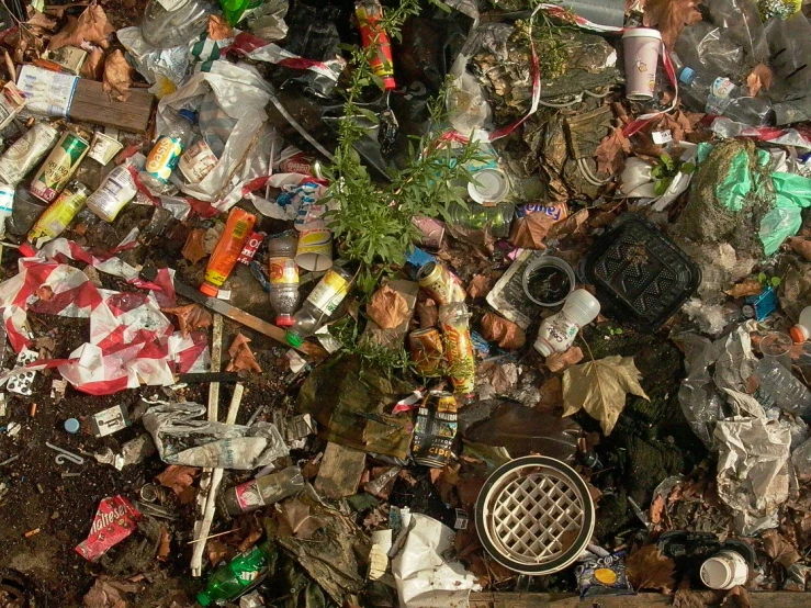 a bunch of garbage sitting on top of a dirt field