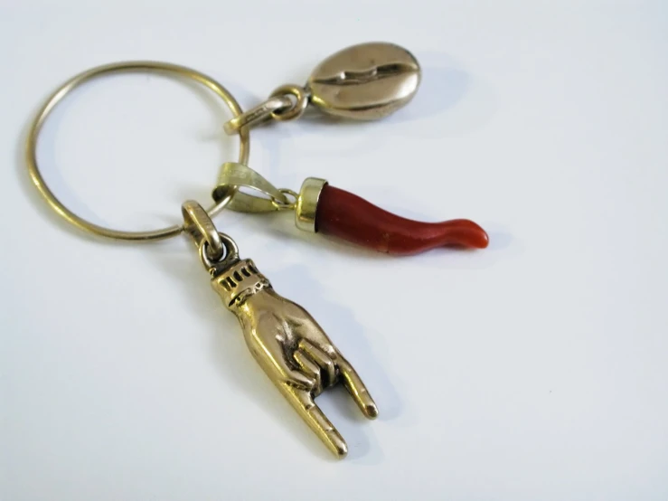 a pair of metal scissors that are on top of a keychain