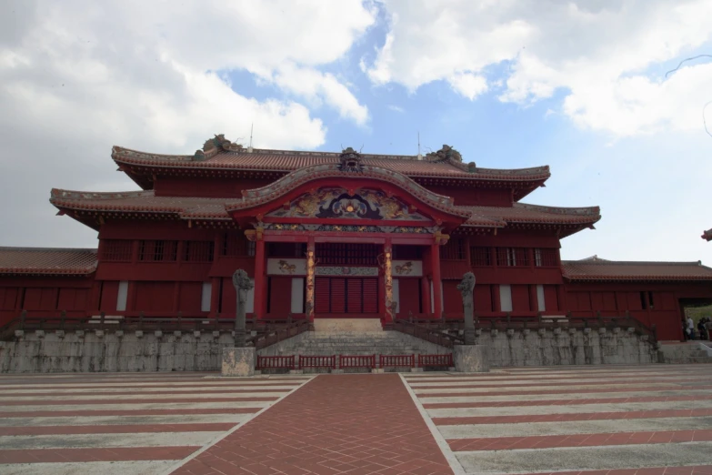 an asian style building with red brick walls and a large window