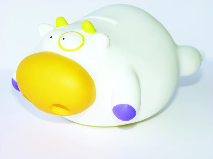 a rubber toy animal with purple and yellow ears