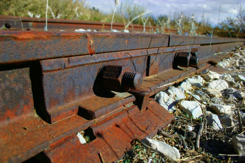 rusty red train car in an abandoned field