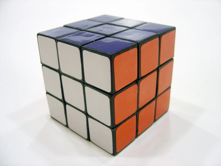 a rubikle cube with orange, blue and white blocks