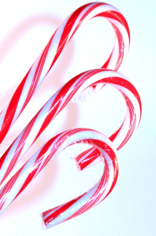 two red and white candy canes in the shape of o's