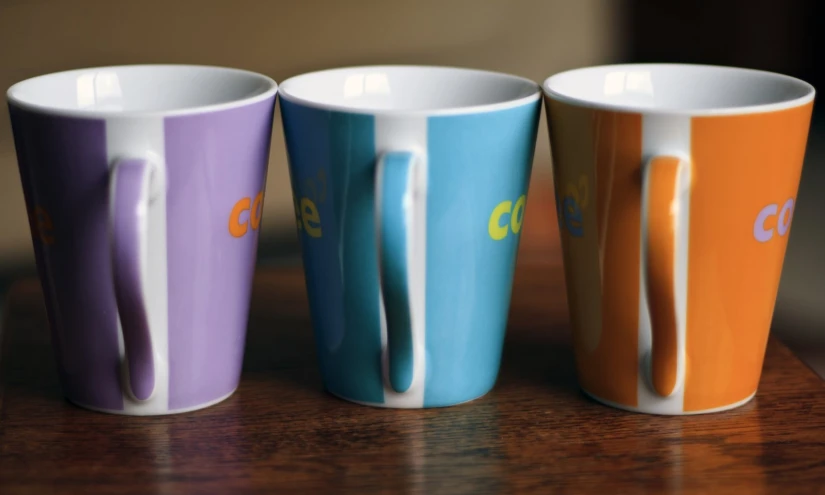 three colorful cups in four different colors with the same name
