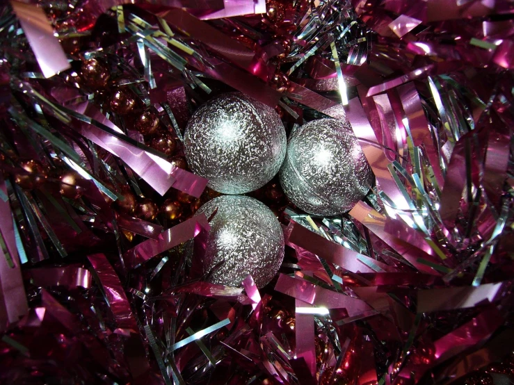 three glass balls on top of pink plastic