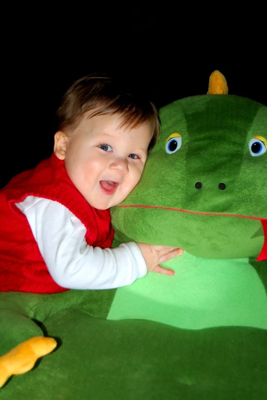 young child smiling with big stuffed animal