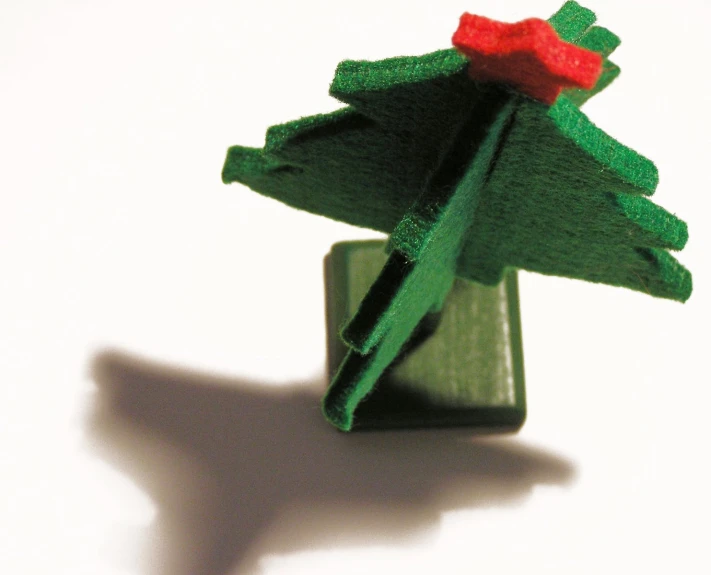 an origami christmas tree with red and green bows