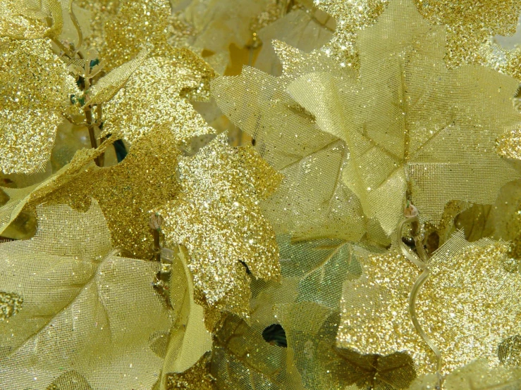 a close - up view of a yellow background with small glitter drops