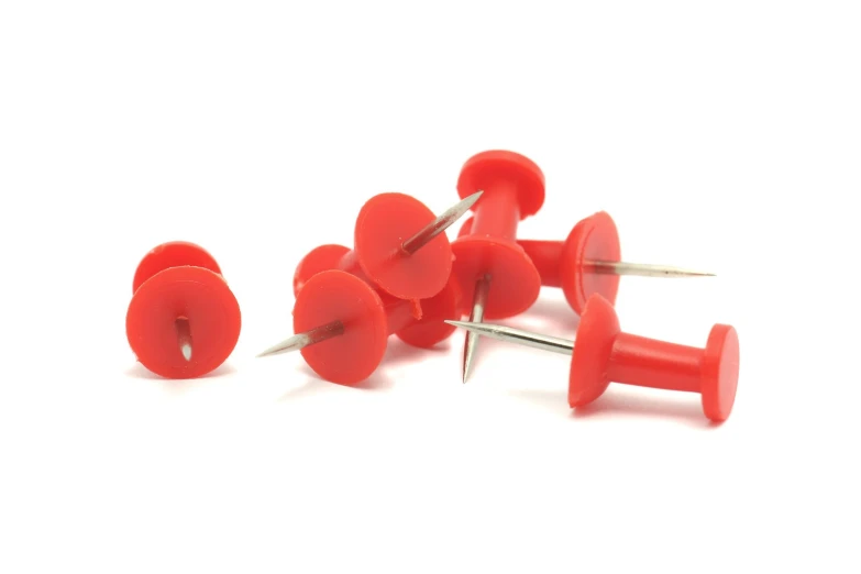 a bunch of red pins are sitting in front of each other