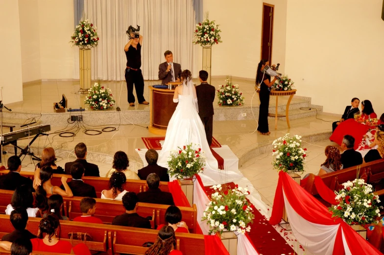 the couple stands before the ceremony on stage