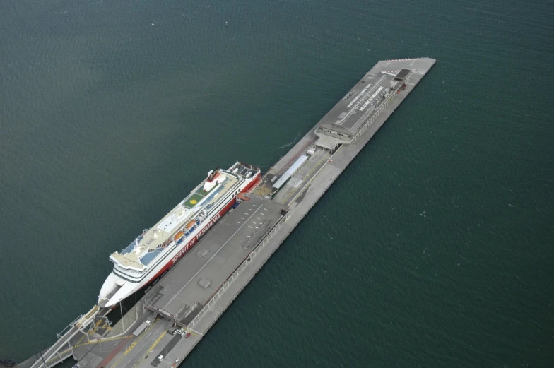 large cruise ship docked on a large body of water