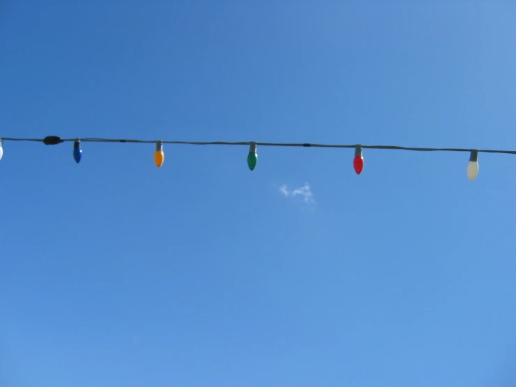 a long line of colored plastic cups attached to a wire