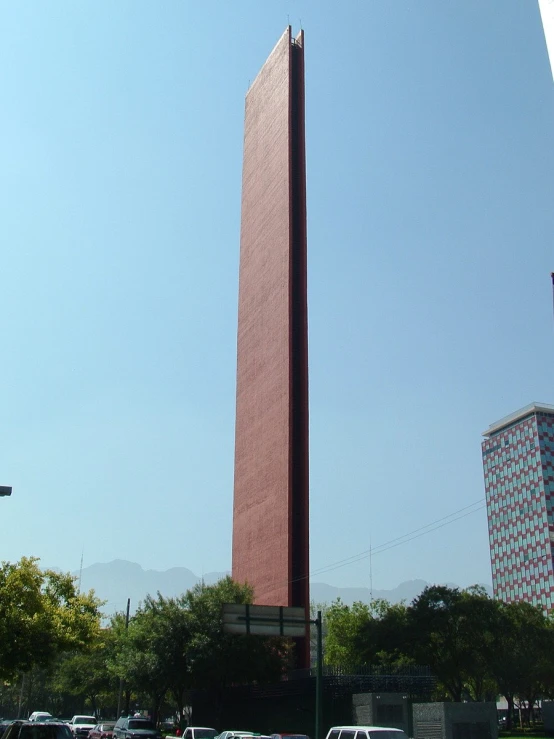 the tall tower stands against the blue sky