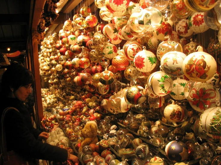 a store with lots of christmas ornaments in front of a window