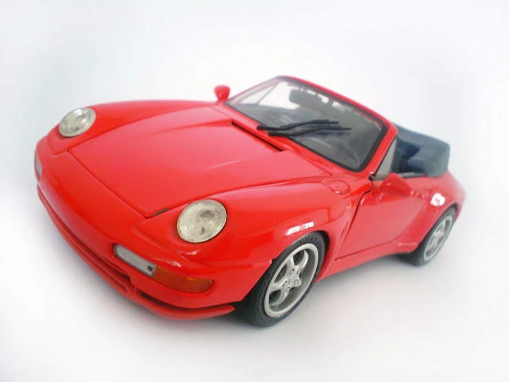 a small red toy sports car