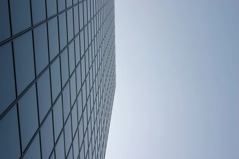 a blue skyscr building seen from below