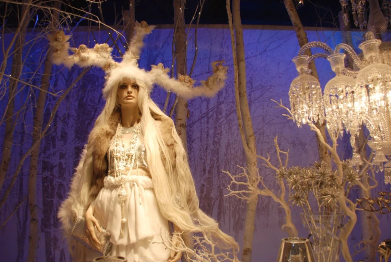 a woman wearing a veil next to some frosting trees