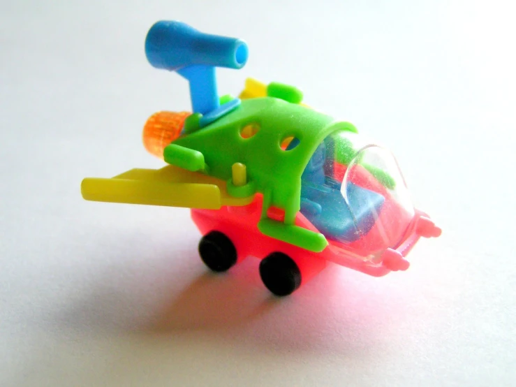 a toy airplane on wheels made from plastic