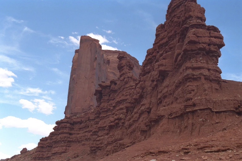 a lone animal on a rock formation near a cliff