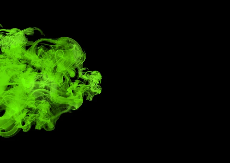 green smoke floating from the top down on a black background