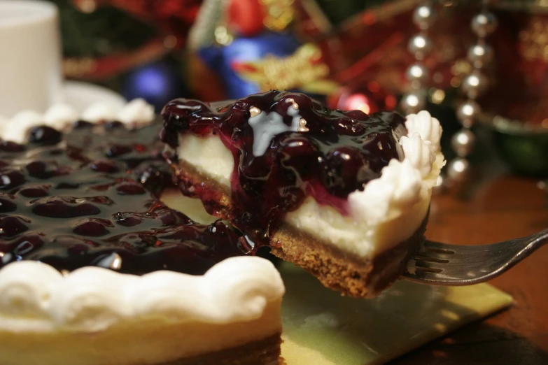 an individual serving of cheesecake with berries on top and blueberries