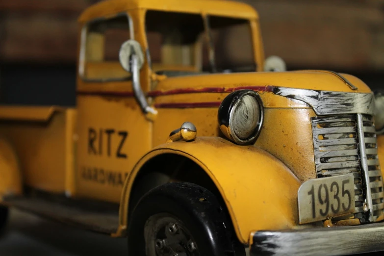 the front end of an old yellow model truck