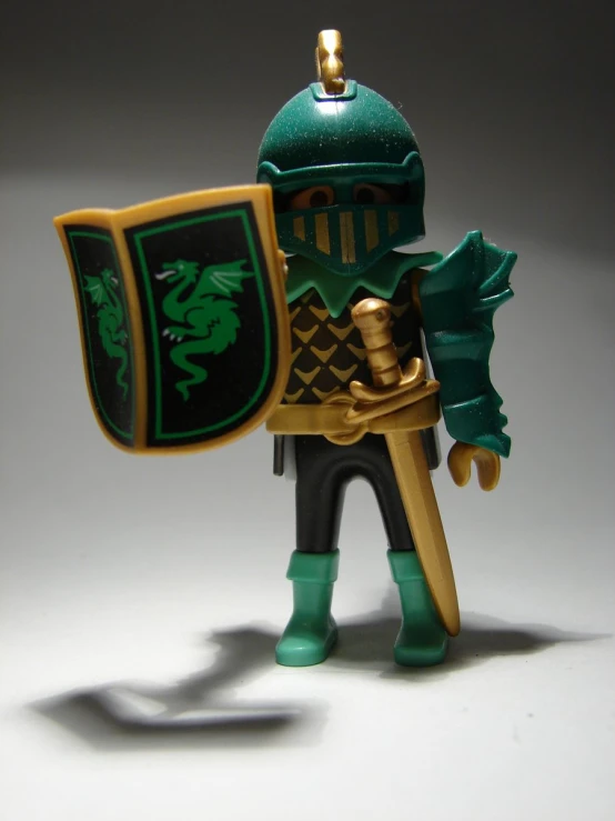the figurine is wearing green armor and holding a sword