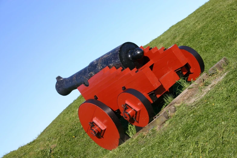 a statue of a cannon on a hillside