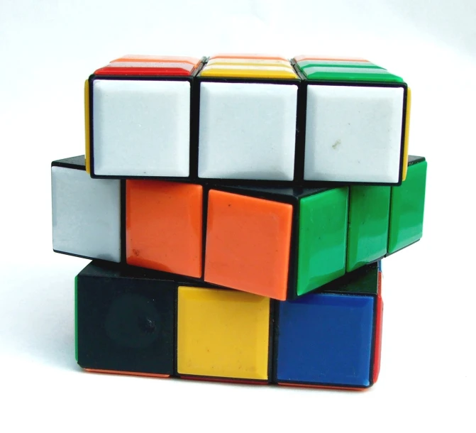 three colorful rubik cubes stacked on each other
