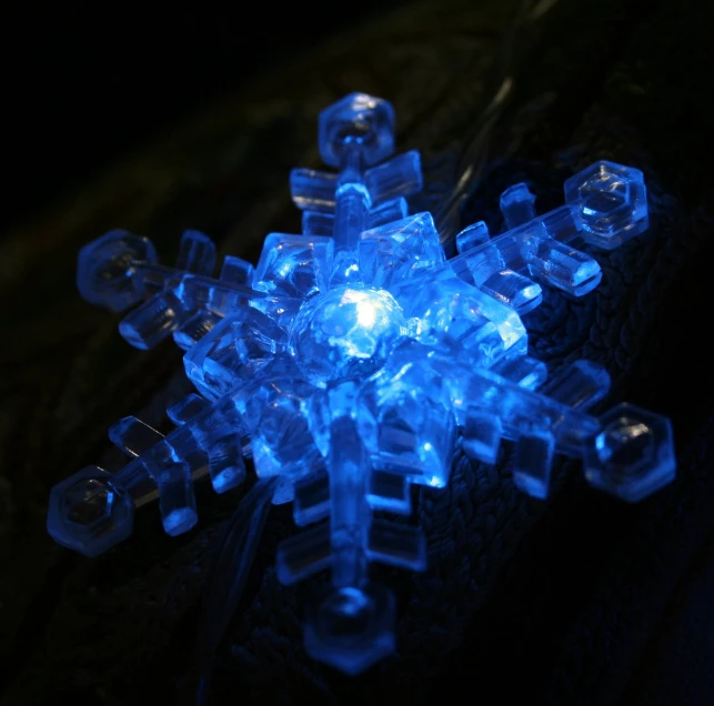 a snowflake with led lights in the dark