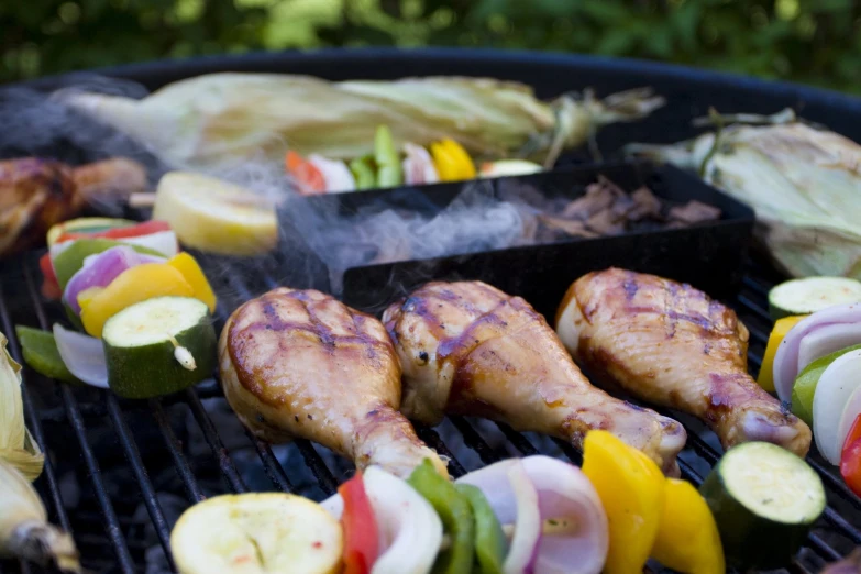 a grill topped with lots of meat and veggies