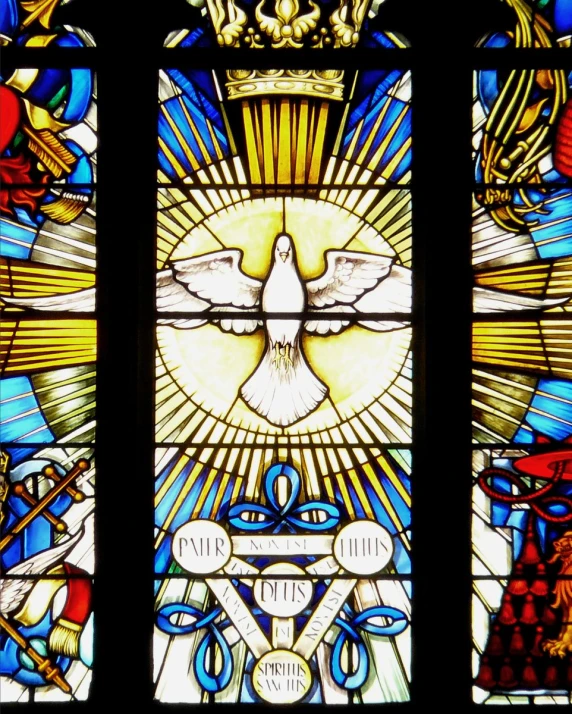 a stained glass window showing the image of a dove and a winged bird
